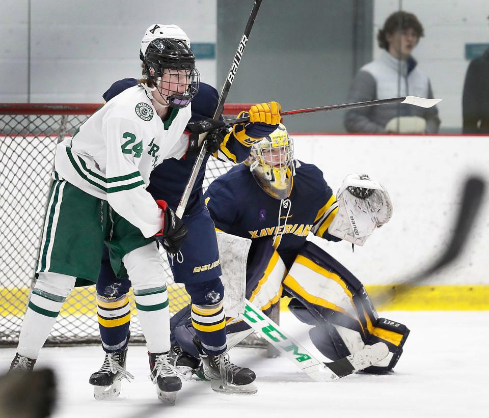 Rams #24 Brendan McLaughlin tries to set up a screen in front of Xaverian goalie Cole Pouliot-Porter.Marshfield hosted Xaverian in boys hockey at The Bog in Kingston on Thursday February 23, 2023 