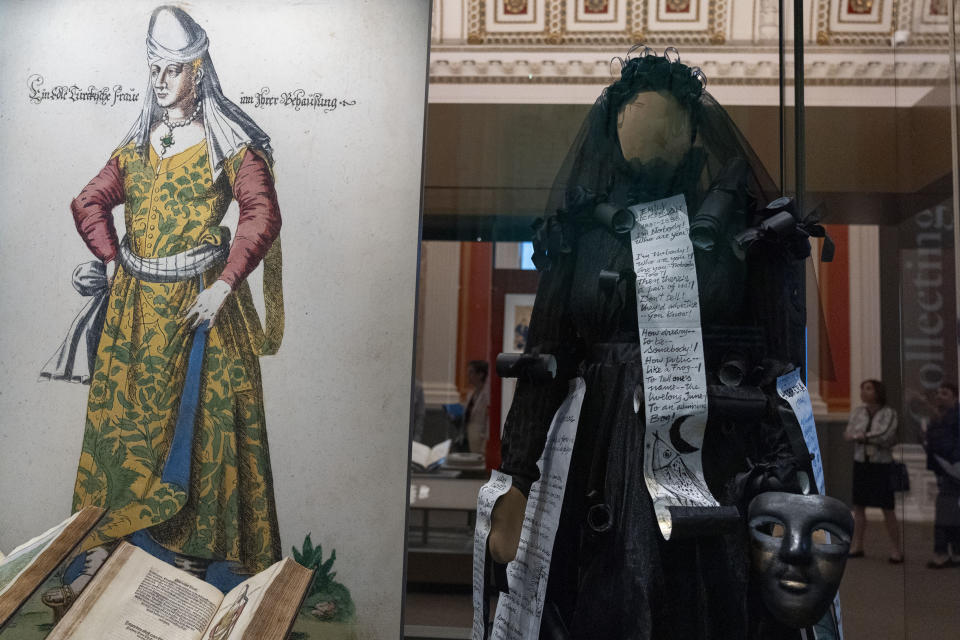 An artwork wedding dress with paper poetry scrolls, right, is among the items on display in the exhibit, "Collecting Memories: Treasures from the Library of Congress," during a media preview at the Library of Congress, Monday, June 10, 2024, in Washington. (AP Photo/Jacquelyn Martin)