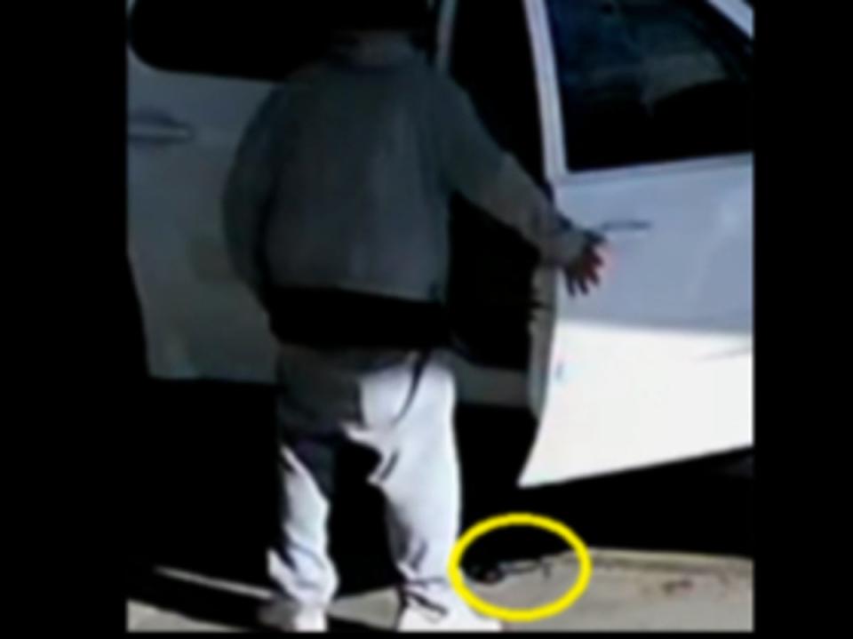 A gun lies at the feet of Avis Damone Coward moments after it accidentally fired and fatally struck a 2-year-old boy  inside the car (U.S. ATTORNEY'S OFFICE, WESTERN DISTRICT OF MICHIGAN)