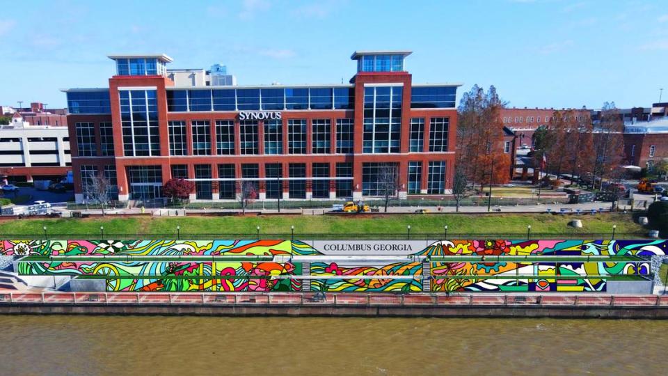 This is an artist’s rendering of what the new mural being painted along the Chattahoochee Riverwalk will look like when completed. It stretches along the riverbank’s three-tiered retaining wall where the Synovus Centre, 1111 Bay Ave., overlooks the Riverwalk between two of the most popular attractions on the riverfront: Waveshaper Island and Woodruff Park. 06/15/2023 Photo courtesy of Dragonfly Trails