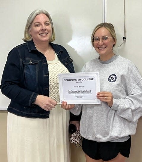 Spoon River College nursing graduate Madi Merritt Severs, (pictured right) was the recipient of the Florence Nightingale Award at the Macomb Campus. Presenting the award was nursing faculty/director Tamatha Schleich, (pictured left).