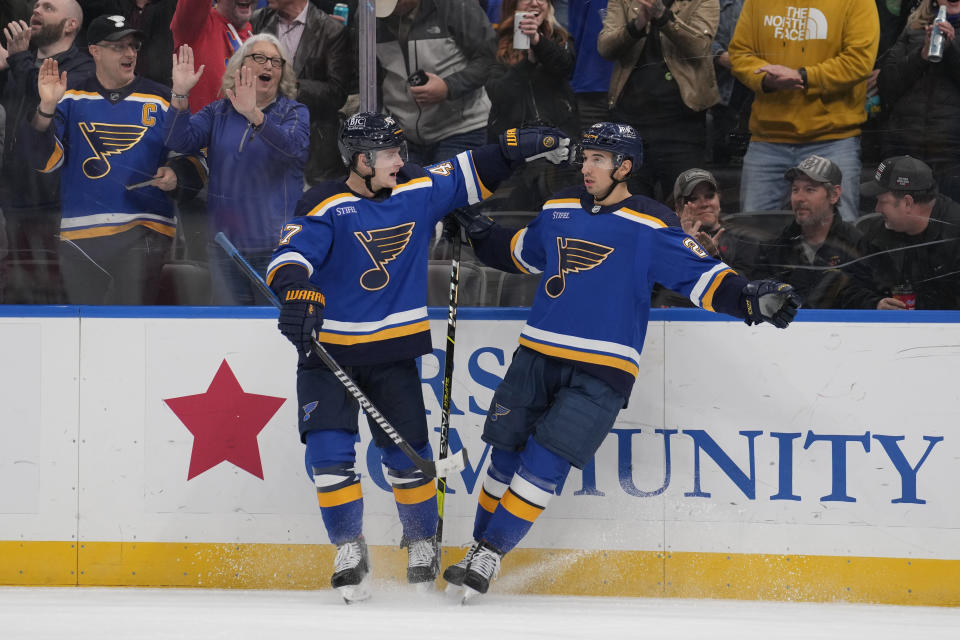 St. Louis Blues' Jordan Kyrou, right, is congratulated by Torey Krug after scoring during the second period of an NHL hockey game against the Tampa Bay Lightning Tuesday, Nov. 14, 2023, in St. Louis. (AP Photo/Jeff Roberson)