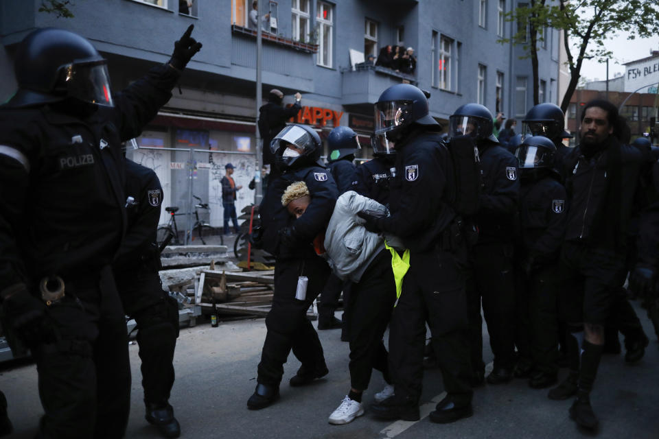 Police officers detain a demonstrator during a May Day rally in Berlin, Germany, Saturday, May 1, 2021. (AP Photo/Markus Schreiber)