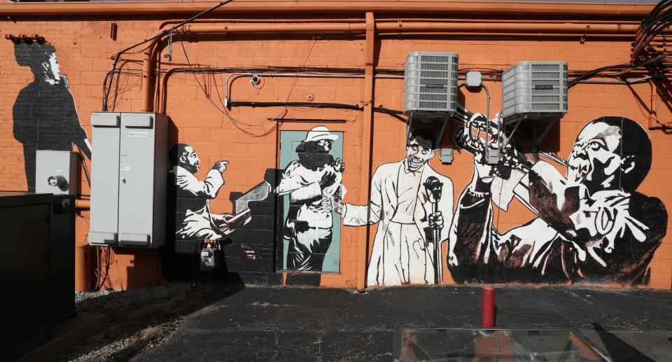 A mural depicting African American Jazz artists is painted on the back of Dirty River Bicycle Works in Akron.