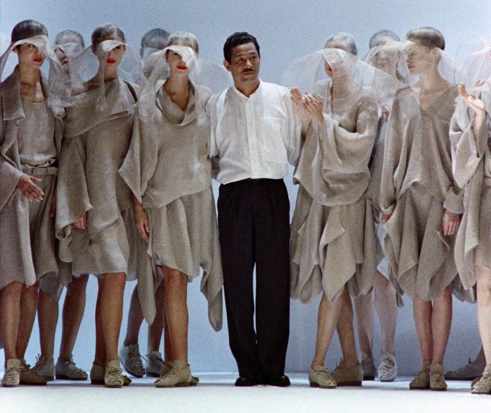 Acknowledging the audience at the end of his Spring-Summer Ready-To-Wear show in Tokyo in 1987 - Naohira Kimura/AFP via Getty Images