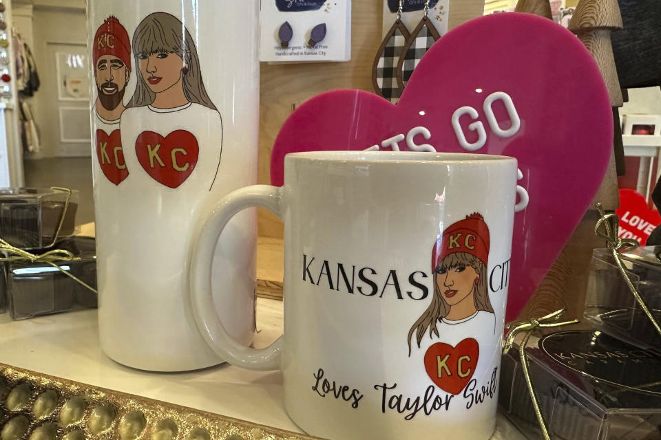 Mugs and cups like these on display at Shop Local KC in Kansas City, Mo., on Monday, Feb. 5, 2024. Coasters, mugs, t-shirts, candles, posters, artwork are some of the items being sold to commemorate the relationship between Taylor Swift and Travis Kelce. (AP Photo/Nick Ingram)