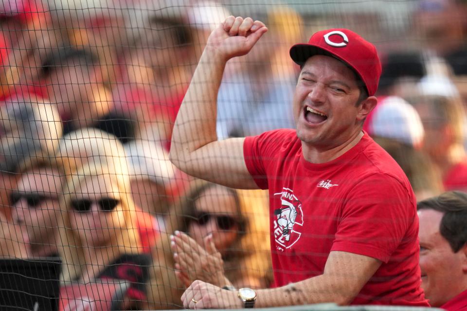 A Cincinnati Reds fans cheers on the team in the ninth inning during a baseball game between the San Diego Padres and the Cincinnati Reds on June 30 at Great American Ball Park.