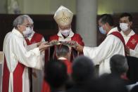 Stephen Chow, center in front, attends the episcopal ordination ceremony as the new Bishop of the Catholic Diocese, in Hong Kong, Saturday, Dec. 4, 2021. The new head of Hong Kong's Catholic diocese expressed hope Saturday that he could foster healing in a congregation and a city divided by the continuing fallout from massive anti-government protests in 2019. (AP Photo/Kin Cheung)