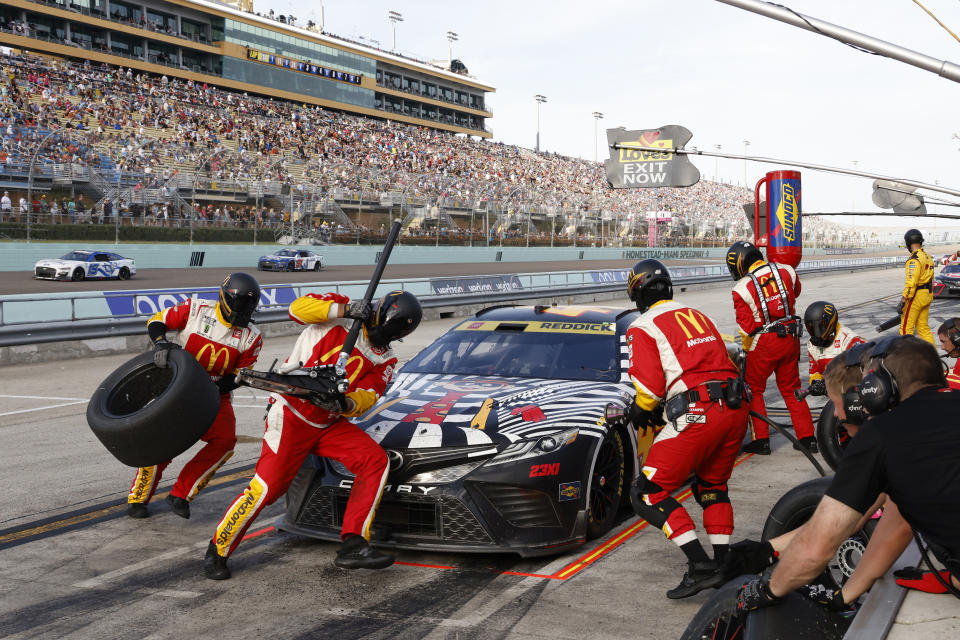 Tyler Reddick (45) makes a pit stop during the NASCAR Cup Series auto race at Homestead-Miami Speedway, Sunday, Oct. 22, 2023 in Homestead, Fla. (AP Photo/Terry Renna)