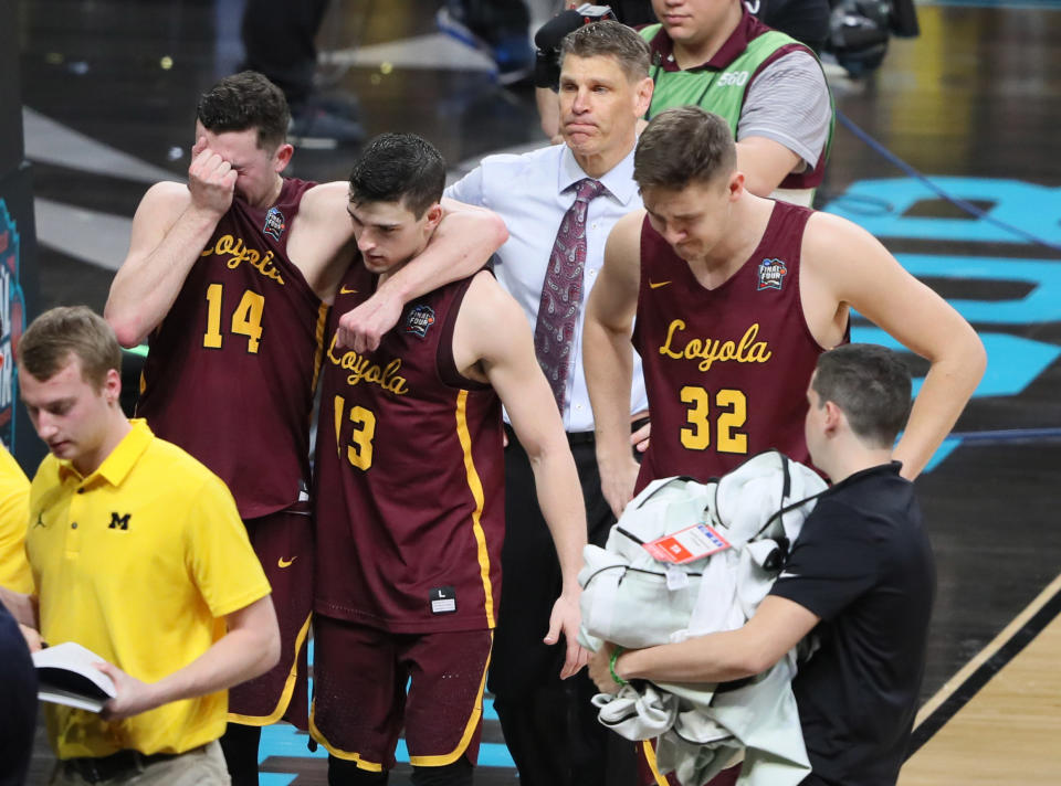 Loyola Ramblers head coach Porter Moser leaves the court with his players including Ben Richardson (14) , Clayton Custer (13) and Carson Shanks (32) after losing to the Michigan Wolverines in the semifinals of the 2018 men’s Final Four at Alamodome. (Reuters)