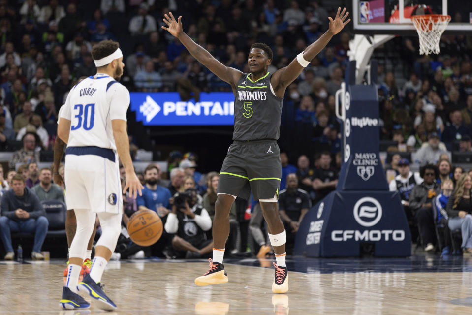 Minnesota Timberwolves guard Anthony Edwards (5) defends Dallas Mavericks guard Seth Curry (30) during the first half of an NBA basketball game, Wednesday, Jan. 31, 2024, in Minneapolis. (AP Photo/Bailey Hillesheim)