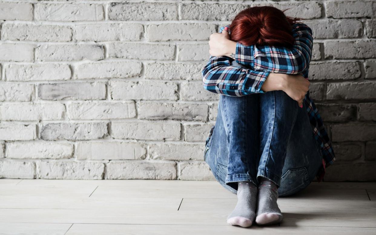 Depressed young crying woman - victim of domestic violence and abuse. Domestic violence - Getty Images