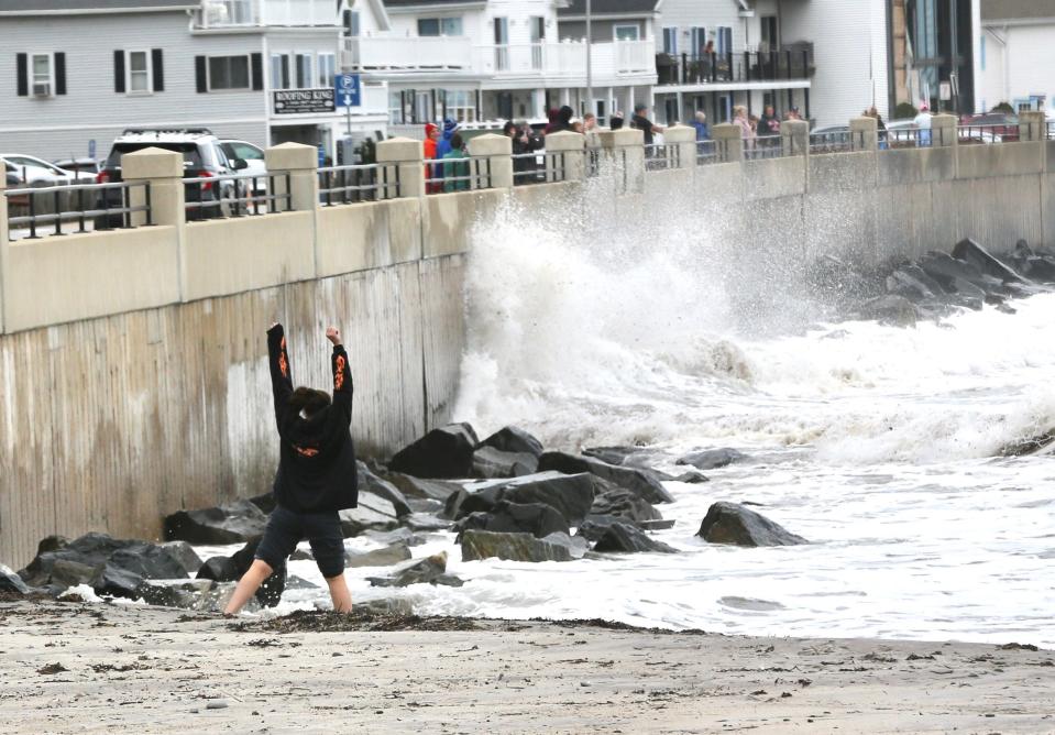 Hampton Beach visitors enjoy the sand and watch the high waves from the impact of Hurricane Lee, which was downgraded to a post-tropical cyclone Saturday, Sept. 16, 2023.