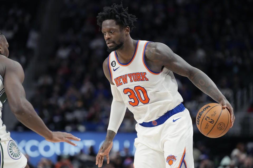 New York Knicks forward Julius Randle (30) controls the ball next to Detroit Pistons center Isaiah Stewart during the second half of an NBA basketball game, Sunday, Jan. 15, 2023, in Detroit. (AP Photo/Carlos Osorio)