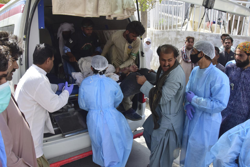 Paramedics and volunteers carry an injured victim of a bomb explosion upon arrival at a hospital, in Quetta, Pakistan, Friday, Sept. 29, 2023. A powerful bomb exploded at a rally celebrating the birthday of Islam's Prophet Muhammad in southwest Pakistan on Friday, killing multiple people and wounding dozens of others, police and a government official said. (AP Photo/Arshad Butt)