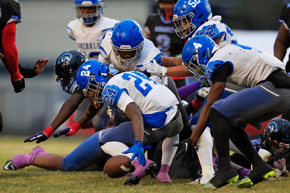 Riverside's R.J. Bertrand (24) scoops up a loose ball on a fumble against Ribault on Nov. 3.