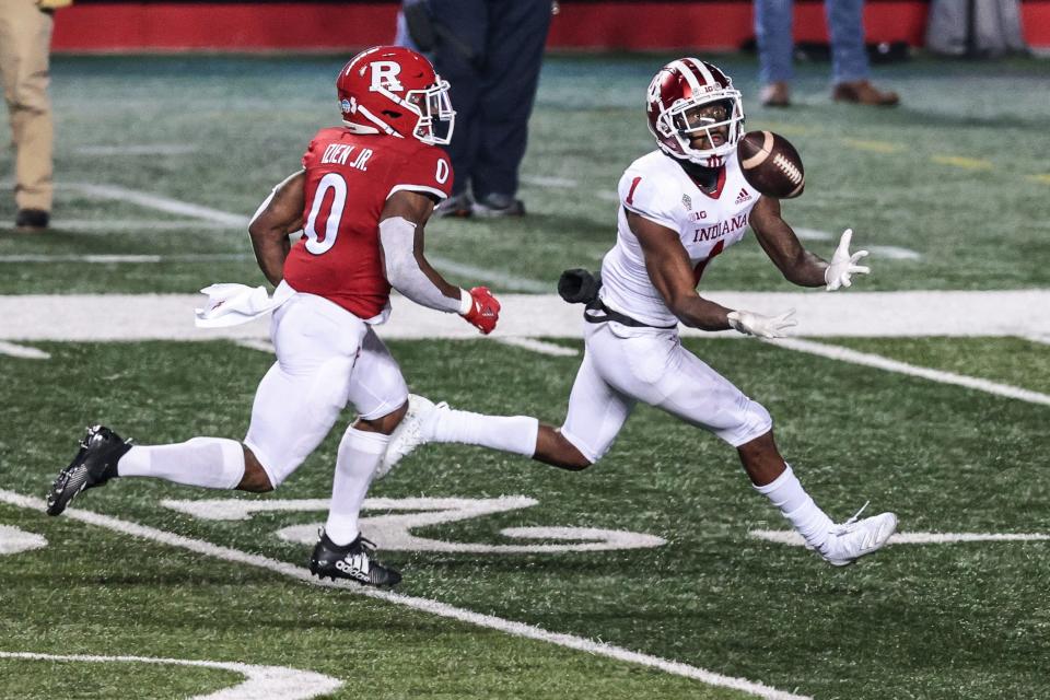 Indiana Hoosiers wide receiver Whop Philyor (1) catches the ball as Rutgers Scarlet Knights defensive back Christian Izien (0) defends during the second half at SHI Stadium.