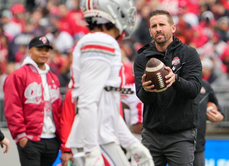 Brian Hartline runs through a drill before the spring football game on April 16.