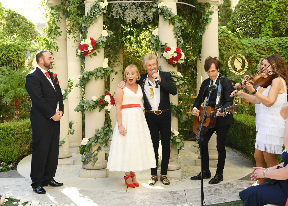 LAS VEGAS, NEVADA - OCTOBER 02: (EXCLUSIVE COVERAGE)  Sir Rod Stewart (R) sings during the wedding of Sharon Cook (C) and Andrew Aitchison (L) from Liverpool, England. The wedding was nearly cancelled due to the Thomas Cook Bankruptcy. Caesars Palace and Delta Air Lines flew the couple and their guests to Las Vegas as originally planned. The Wedding took place at Caesars Palace on October 02, 2019 in Las Vegas, Nevada. (Photo by Denise Truscello/WireImage)