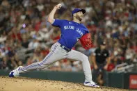 FILE -Toronto Blue Jays relief pitcher Anthony Bass throws to a Minnesota Twins batter during the ninth inning of a baseball game Thursday, Aug. 4, 2022, in Minneapolis. Toronto Blue Jays pitcher Anthony Bass apologized Tuesday, May 30, 2023 for sharing a homophobic social media post on his Instagram account. (AP Photo/Bruce Kluckhohn, File)