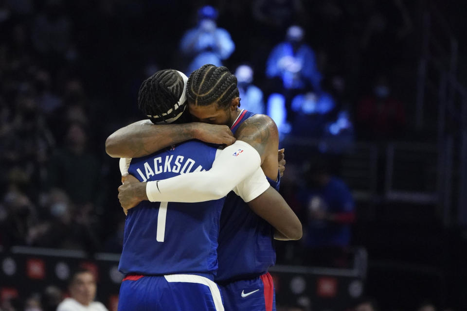 Reggie Jackson and Paul George hug during a 2021 game with the Los Angeles Clippers. (AP Photo/Marcio Jose Sanchez)