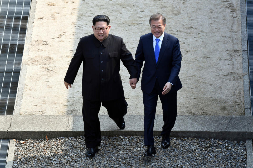 FILE - In this April 27, 2018, file photo, North Korean leader Kim Jong Un, left, and South Korean President Moon Jae-in cross the military demarcation line at the border village of Panmunjom in Demilitarized Zone. On both sides of the world's most heavily armed border Thursday, June 25, 2020, solemn ceremonies will mark the 70th anniversary of the outbreak of a war that killed and injured millions, left large parts of the Korean Peninsula in rubble and technically still continues. (Korea Summit Press Pool via AP. File)