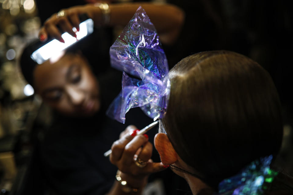 A model is prepared backstage before the Brandon Maxwell collection is modeled during Fashion Week, Saturday, Feb. 8, 2020, in New York. (AP Photo/John Minchillo)