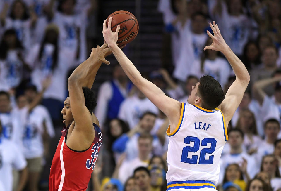 UCLA forward TJ Leaf, right, grabs a rebound away from Arizona guard Allonzo Trier during the first half of an NCAA college basketball game, Saturday, Jan. 21, 2017, in Los Angeles. (AP Photo/Mark J. Terrill)