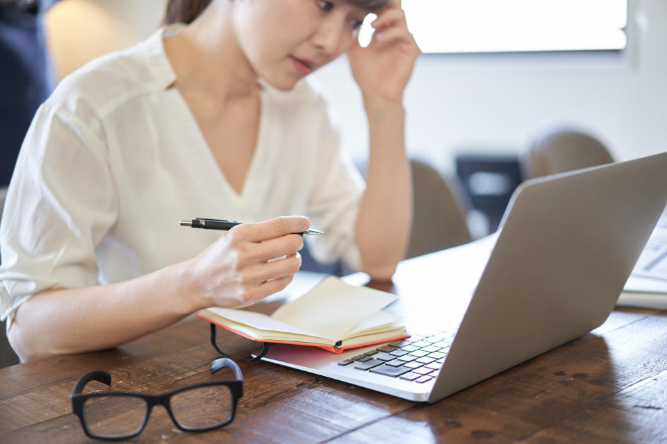 Asian women suffering from deadlines for computer work