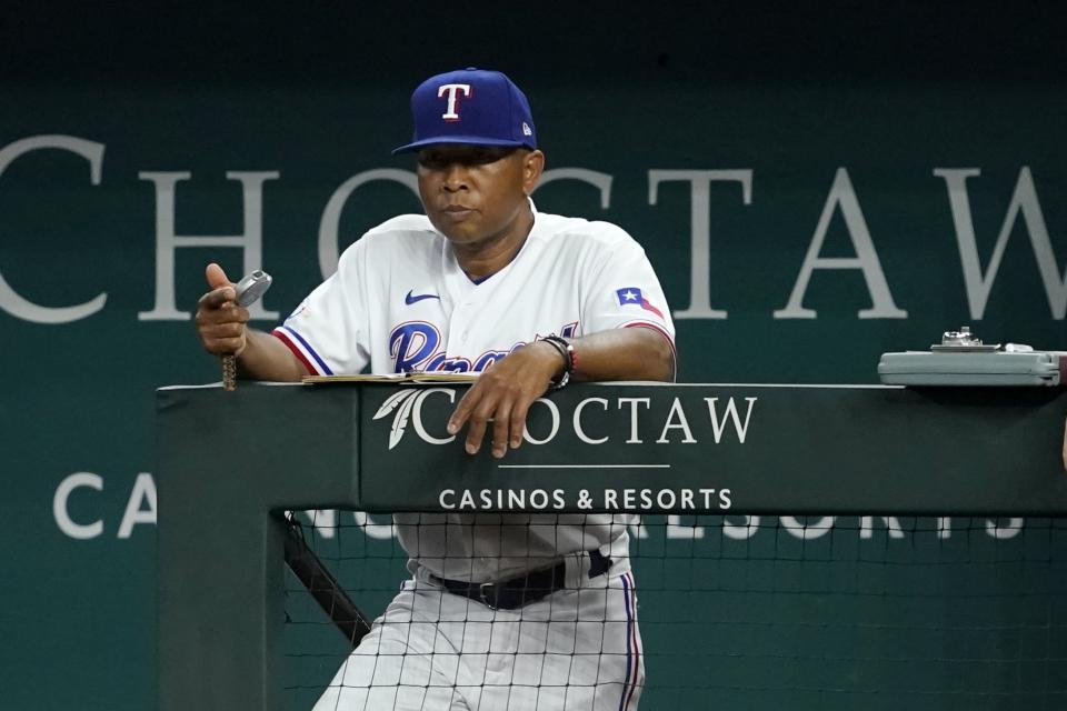 Texas Rangers interim manager Tony Beasley watches the team's play against the Oakland Athletics during the first inning of a baseball game in Arlington, Texas, Monday, Aug. 15, 2022. (AP Photo/Tony Gutierrez)