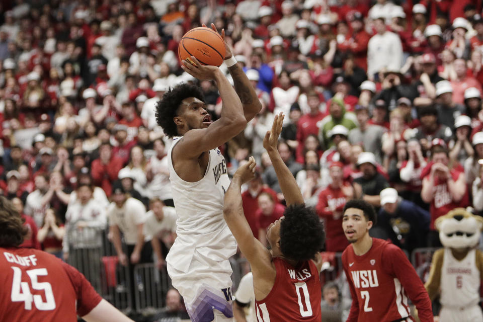 Washington forward Keion Brooks Jr., center left, shoots while pressured by Washington State forward Jaylen Wells (0) during the second half of an NCAA college basketball game, Thursday, March 7, 2024, in Pullman, Wash. (AP Photo/Young Kwak)