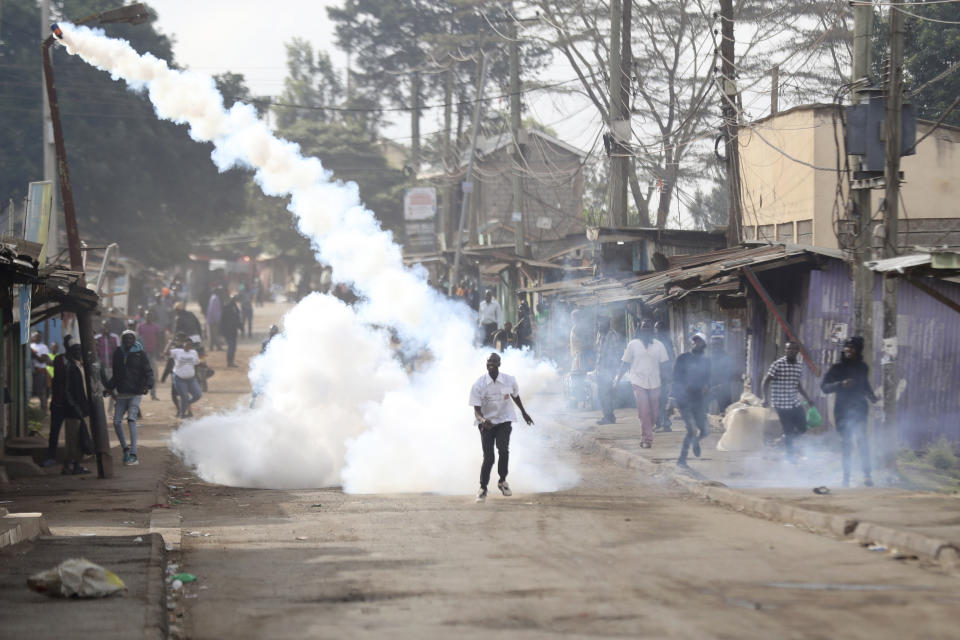 A teargas canister flies through the air as police clash with protesters during a protest by supporters of Kenya's opposition leader Raila Odinga over the high cost of living and alleged stolen presidential vote, in Nairobi, Monday, March 20, 2023. (AP Photo/Brian Inganga)