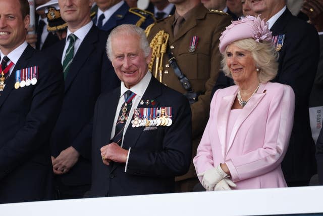 Charles, wearing his large collection of medals, and Camilla stand side by side at the UK’s national commemorative event for the 80th anniversary of D-Day in Portsmouth