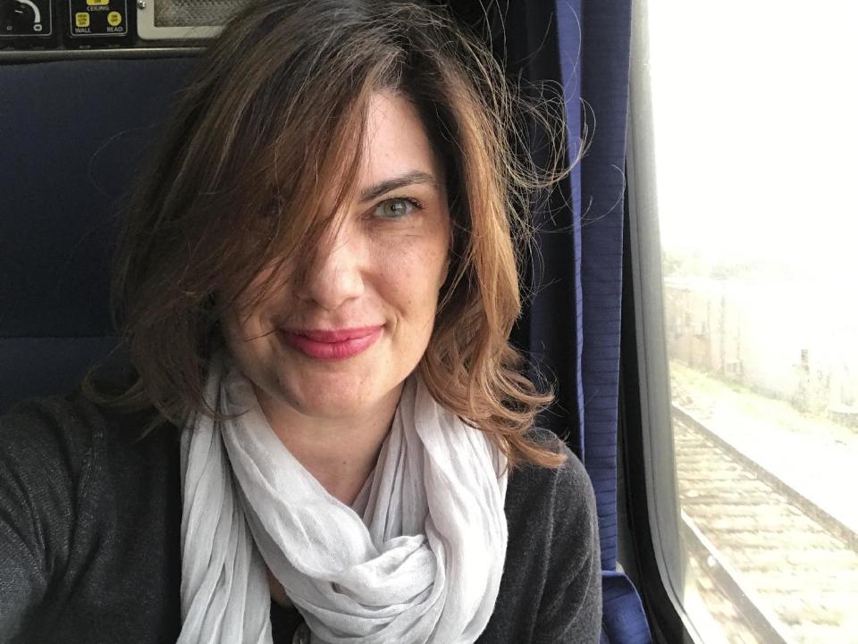 Associated Press Tampa Bay Correspondent Tamara Lush poses for a photo, Jan. 17, 2017, on the rails. AP Tampa correspondent Tamara Lush spent 15 days traveling via train across the U.S. as part of Amtrak's residency program, designed for creative professionals to spend time writing on the rails. She spoke with dozens of people _ fellow travelers, friends and family waiting for loved one at stations, train workers _ and filed occasional dispatches for the Tales on a Train project. (AP Photo/Tamara Lush)
