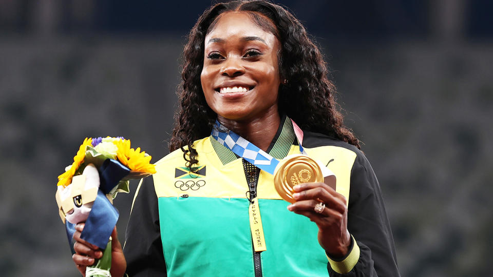 Elaine Thompson-Herah, pictured here with her gold medal after winning the 100m at the Tokyo Olympics.