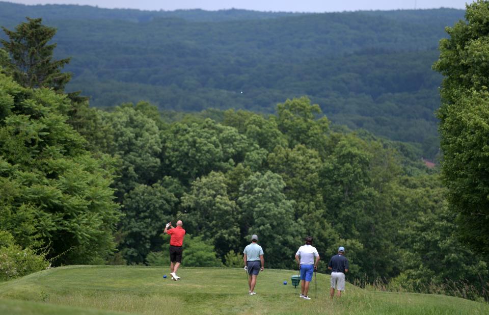 A foursome enjoys a spectacular view during Sunday's final round of the Walter Cosgrove Four Ball tournament at Green Hill Municipal Golf Course.