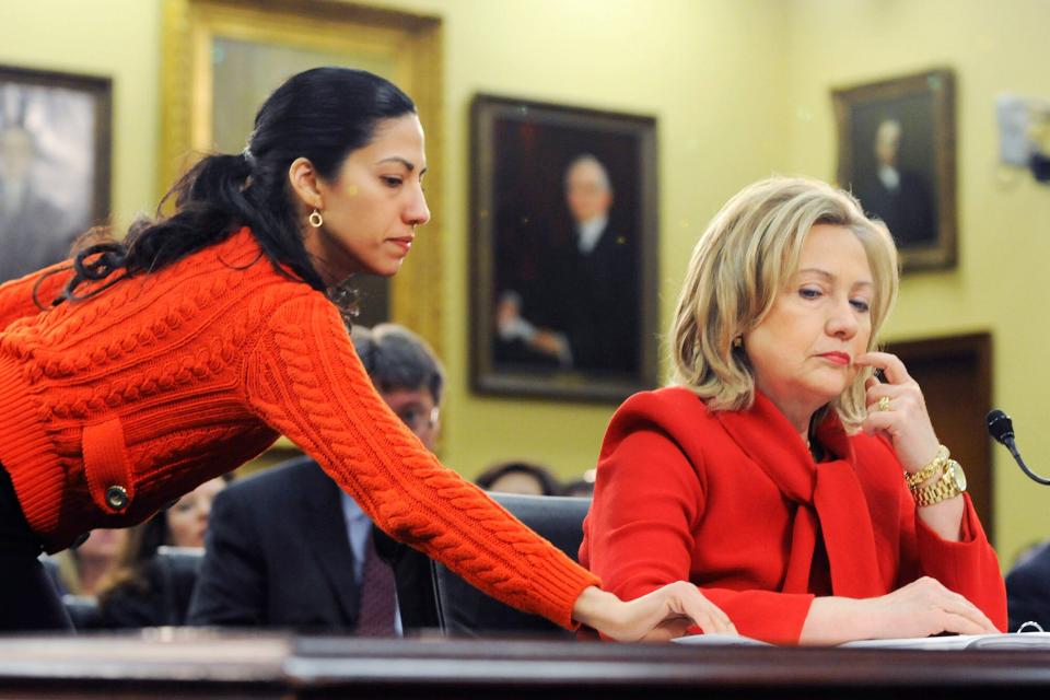 Secretary of State Hillary Clinton (R) receives a note from her aide Huma Abedin (L) as she testifies about the State Department's FY2012 budget during a hearing of the State, Foreign Operations and Related Programs Subcommittee of the House Appropriations Committee in the Rayburn House Office Building on March 10, 2011 in Washington, DC