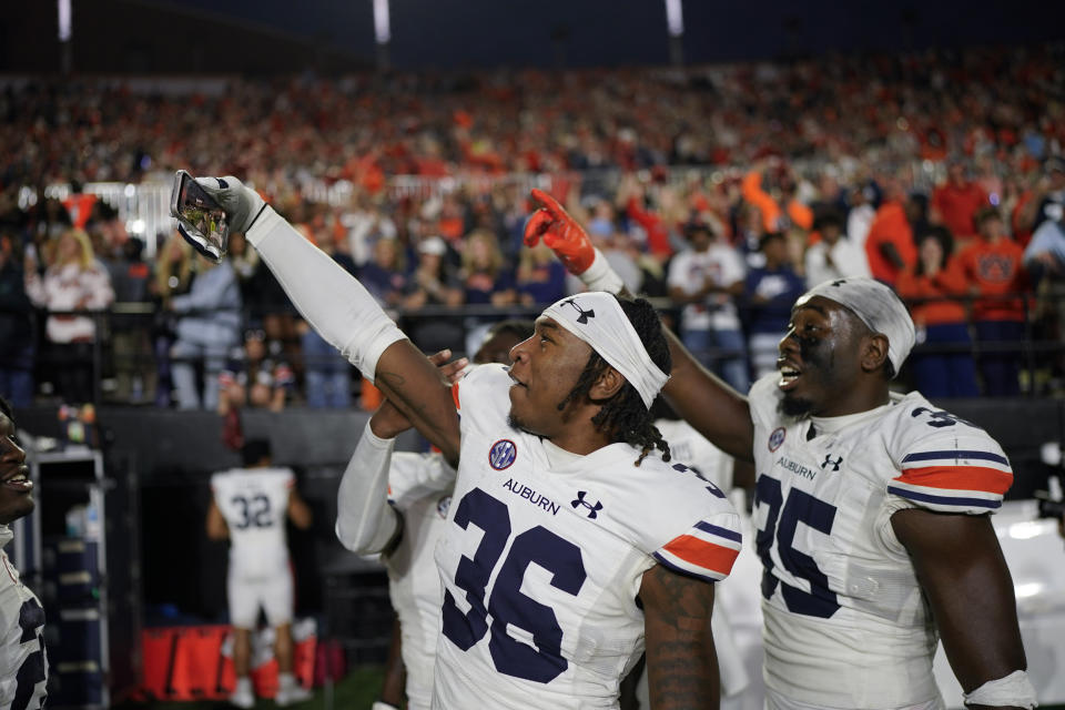 Auburn cornerback Jaylin Simpson (36) and linebacker Jalen McLeod, right, celebrate the team's win against Vanderbilt after an NCAA college football game Saturday, Nov. 4, 2023, in Nashville, Tenn. (AP Photo/George Walker IV)