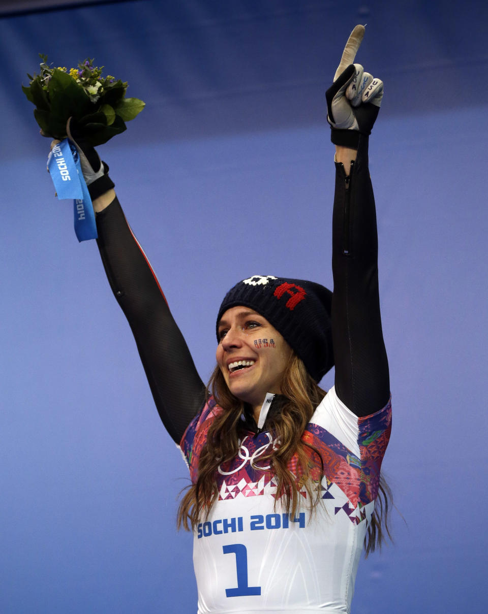 Noelle Pikus-Pace of the United States cries during the flower ceremony after winning the silver medal during the women's skeleton competition at the 2014 Winter Olympics, Friday, Feb. 14, 2014, in Krasnaya Polyana, Russia. (AP Photo/Dita Alangkara)