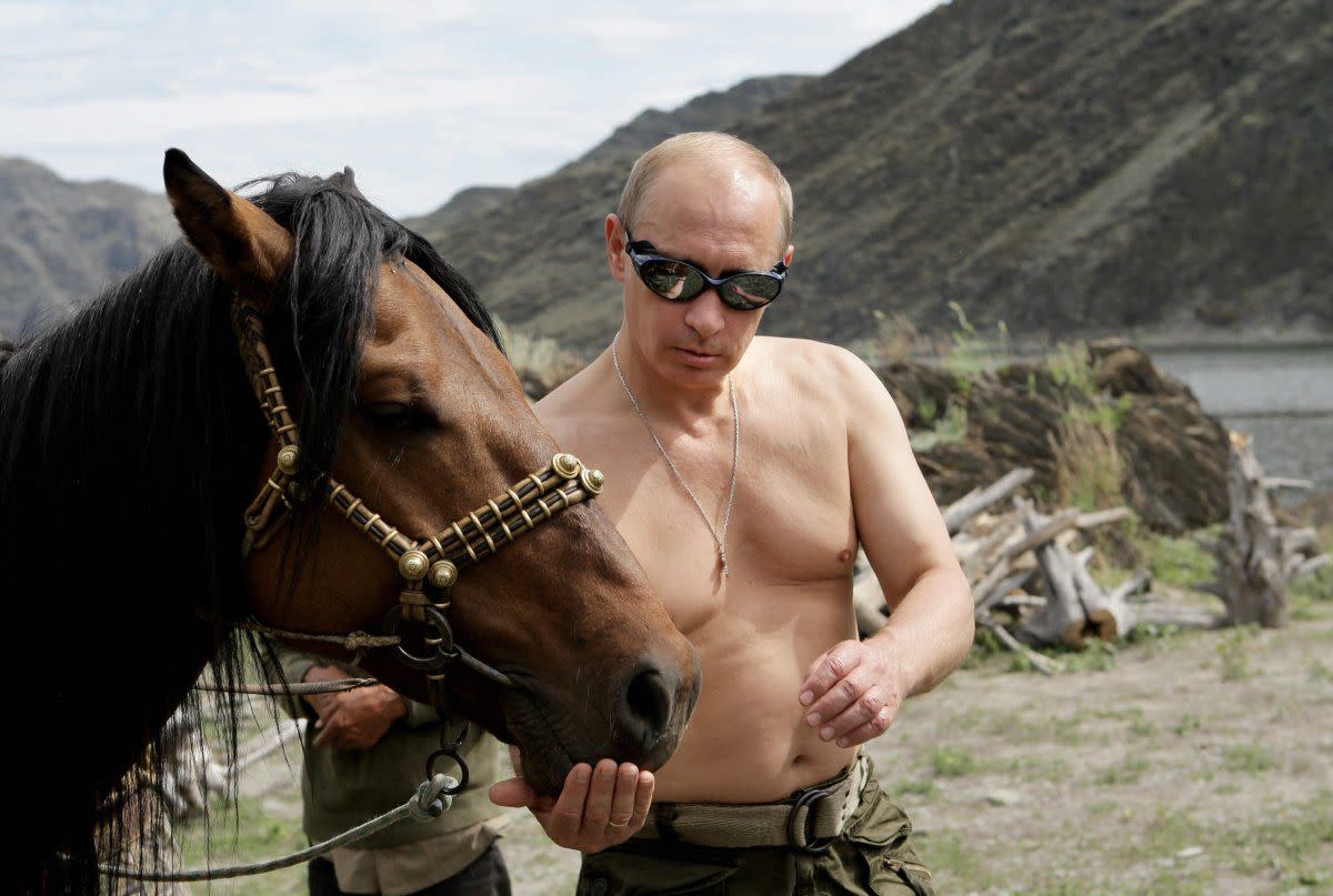 Russian Prime Minister Vladimir Putin is pictured with a horse during his vacation outside the town of Kyzyl in Southern Siberia on Aug. 3, 2009. 