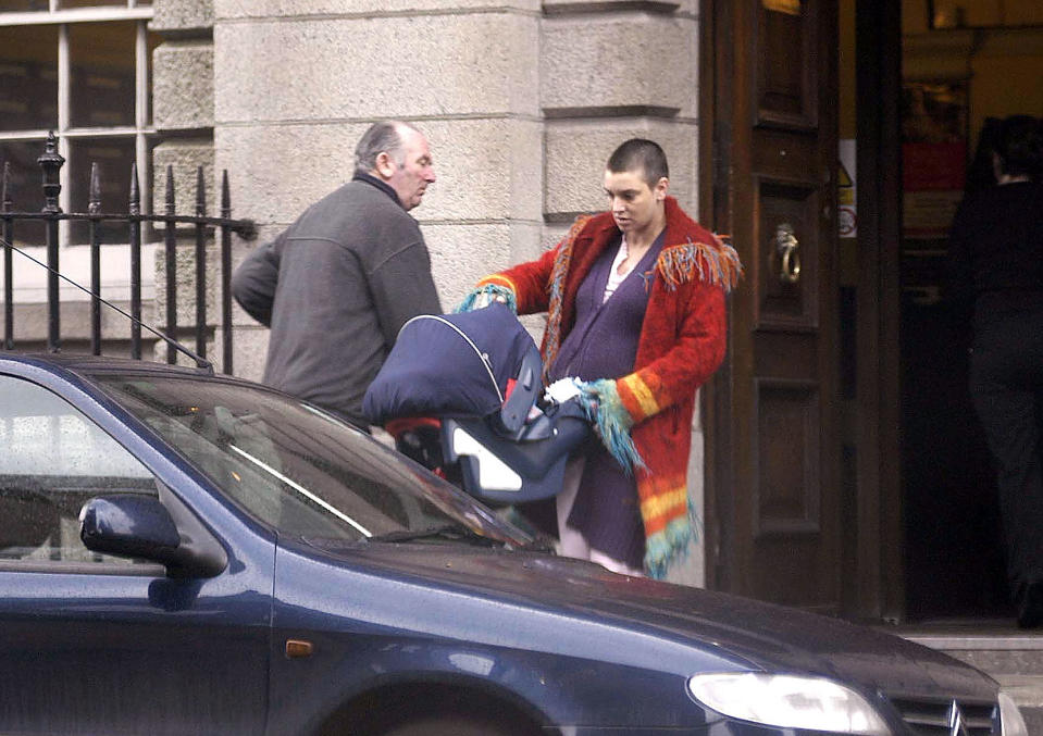Sinead O’Connor leaves Holles Street Maternity Hospital with her new baby son Shane on March 13, 2004. <cite>ShowBiz Ireland/Getty Images</cite>
