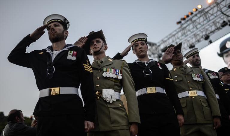 Australian soldiers salute during the ceremony marking the 99th anniversary of the Anzac Day, in Canakkale, Turkey, on April 25, 2014