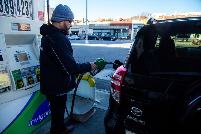 A man pumps gas at a gas station in the Brooklyn, N.Y.