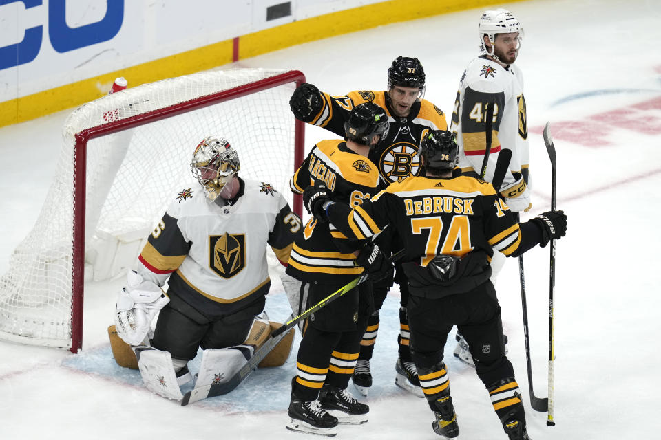 Boston Bruins left wing Brad Marchandis congratulated after his goal against Vegas Golden Knights goaltender Logan Thompson during the second period of an NHL hockey game, Monday, Dec. 5, 2022, in Boston. (AP Photo/Charles Krupa)