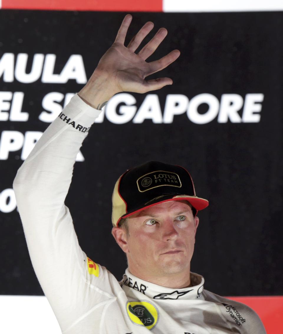 Lotus F1 Formula One driver Kimi Raikkonen of Finland waves after the Singapore F1 Grand Prix at the Marina Bay street circuit in Singapore September 22, 2013. REUTERS/Pablo Sanchez (SINGAPORE - Tags: SPORT MOTORSPORT F1)