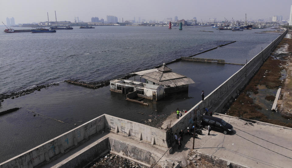 This aerial view shows a giant sea wall which is used as a barrier to prevent sea water from flowing into land and cause flooding in Jakarta, Indonesia. in Jakarta, Indonesia, Saturday, July 27, 2019. Indonesia's President Joko Widodo said in an interview that he wants to see the speedy construction of the giant sea wall to save the low-lying capital of Jakarta from sinking under the sea, giving renewed backing to a long-delayed multi-billion-dollar mega project. (AP Photo/Achmad Ibrahim)