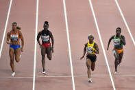 Dafne Schippers, of the Netherlands, Kelly-Ann Baptiste, of Trinidad And Tobago, Shelly-Ann Fraser-Pryce, of Jamaica, and Murielle Ahouré, of The Ivory Coast, from left to right, compete in the women's 100 meter semifinal during the World Athletics Championships in Doha, Qatar, Sunday, Sept. 29, 2019. (AP Photo/Martin Meissner)