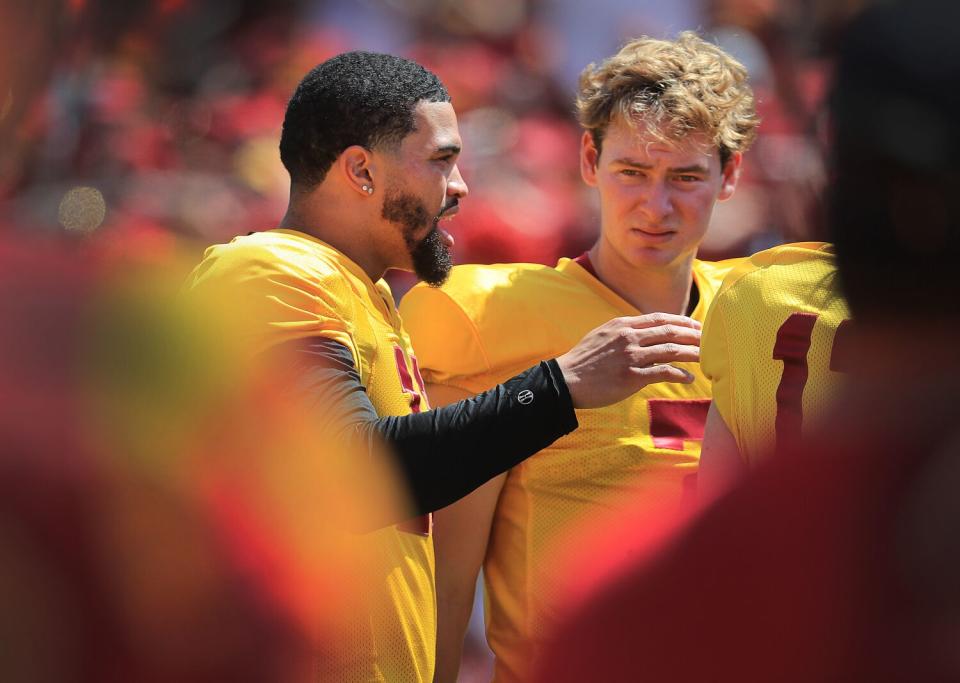 USC's Caleb Williams, left, talks with fellow quarterback Miller Moss during the Trojans' spring game April 15, 2023.