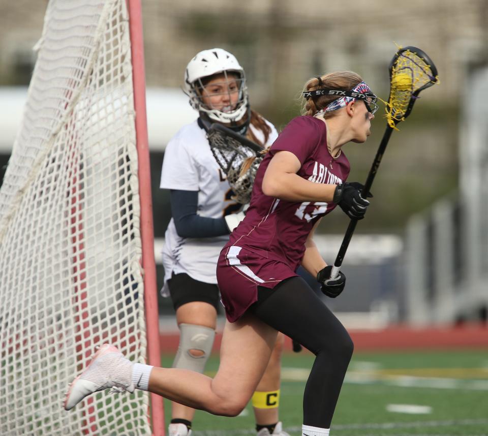 Arlington's Talia Berardo circles Lourdes' goalie Norah Zuidema during Tuesday's game on May 3, 2022. 