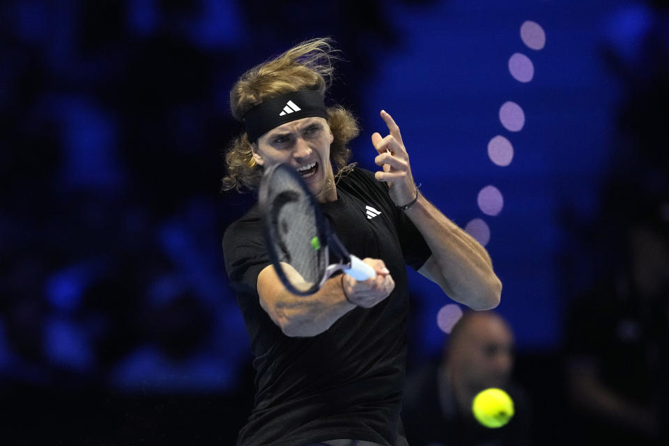 Germany's Alexander Zverev returns the ball to Spain's Carlos Alcaraz during their singles tennis match of the ATP World Tour Finals at the Pala Alpitour, in Turin, Italy, Monday, Nov. 13, 2023. (AP Photo/Antonio Calanni)